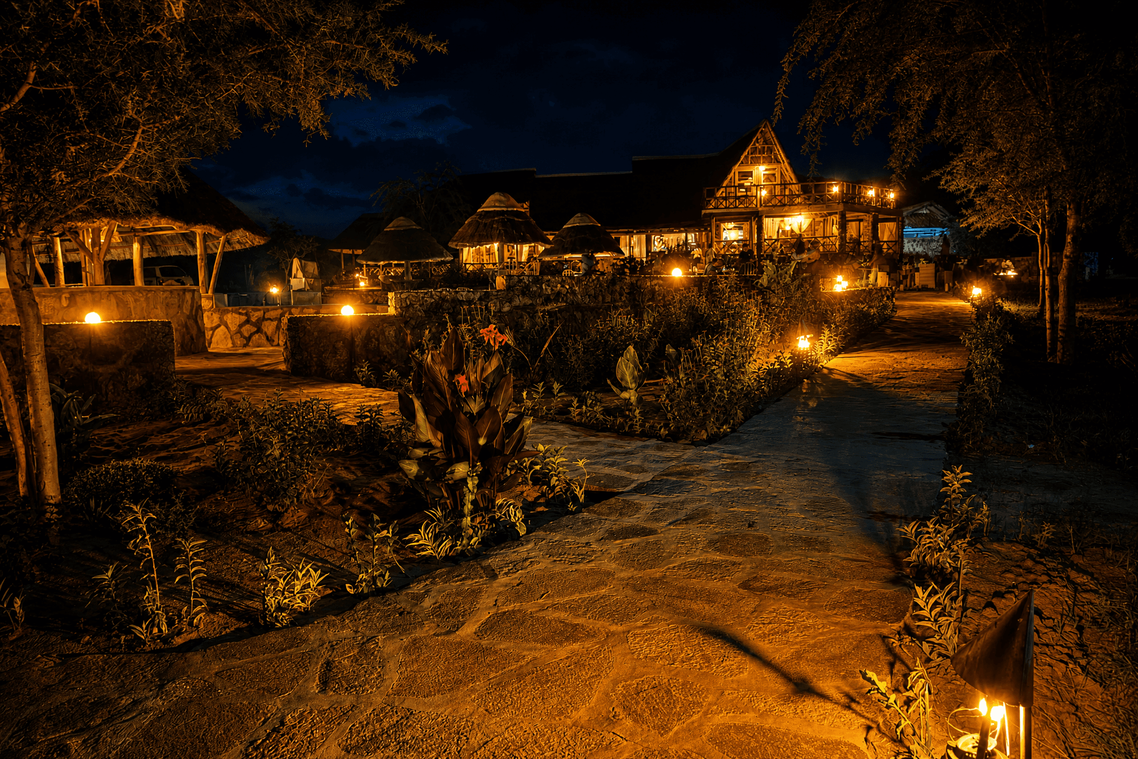 The Elephant Oasis lit stone pathway at night leading to the main lodge, Murchison Falls Uganda